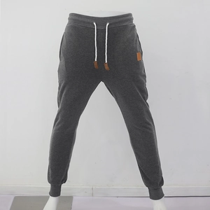 Close-up of men's dark grey knit joggers with white drawstring and elastic waistband