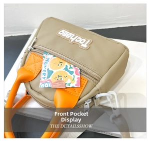 Detail shot of the front pocket and Tochaso logo on a kids khaki and orange nylon bag