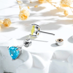 Sparkling heart-shaped nest earrings with blue and yellow gems and screw-on backs