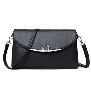 Elegant black lychee texture crossbody bag with heart-accented metal buckle on white background