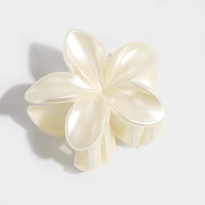 Macro detail of the elegant pearlescent white lily flower hair claw clip for women