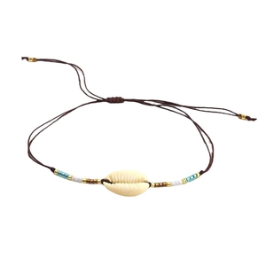 Bohemian adjustable cord bracelet with natural cowrie shell and evil eye beads