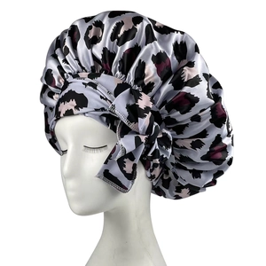 Detail of silk-like leopard print sleep cap with silver-grey satin and stylish side ribbon