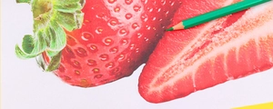 Close-up of green erasable colored pencil drawing a vibrant strawberry illustration