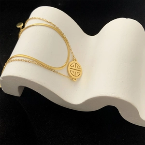 Double-layered gold snake chain bracelet with a vintage Chinese character round pendant