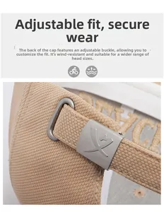 Detail of adjustable metal buckle and twill fabric texture on a beige baseball cap