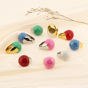 Close-up of enamel Morandi color rings with 18k gold plating on elegant beige silk fabric