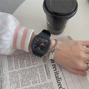 Square black student sports watch with silicone strap shown in a lifestyle daily setting