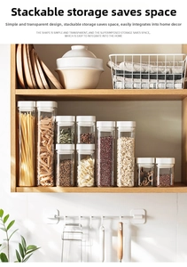 Stackable transparent food storage jars with white lids on a wooden kitchen shelf