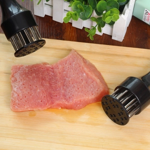 Dual stainless steel meat tenderizers with black handles on a wooden cutting board