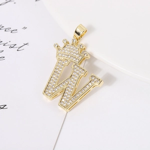 Detail of a gold crown-topped letter W pendant with micro-pave cubic zirconia crystals