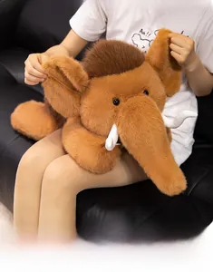 Detailed close-up of a large fluffy mammoth plush toy held to show soft brown fur texture