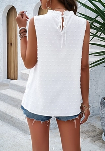 Back view of a white sleeveless blouse with swiss dot texture and a back tie collar