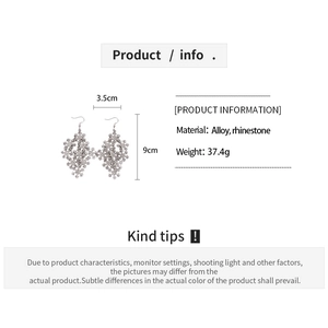 Detailed view of rhinestone snowflake drop earrings with size specs and dimensions