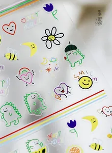 Detail view of cartoon dinosaur and heart patterns on ultra-thin nail art stickers