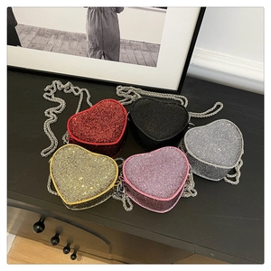 Detail showing heart-shaped mini bags in five glittery colors with metal chains