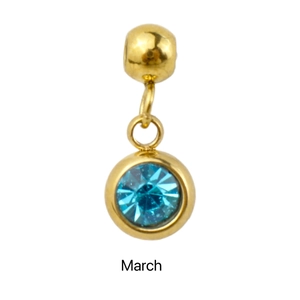Macro view of gold stainless steel March birthstone charm with faceted blue crystal