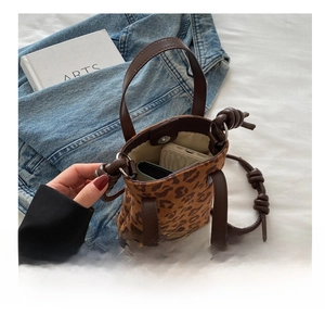 Detail shot of leopard print bucket bag interior showing spacious storage and magnetic closure