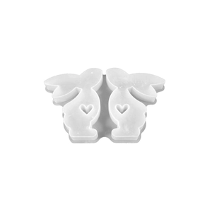 DIY silicone mold featuring two rabbit shapes with heart cutouts for candle making