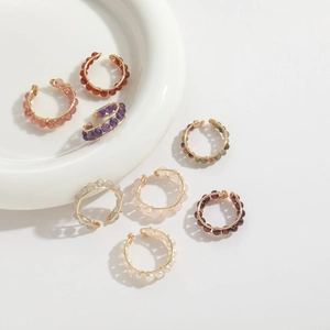 Close-up of handmade 14K gold-plated wire-wrapped rings with colorful natural beads