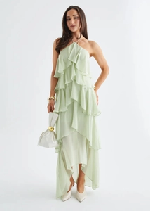 Detail of elegant tiered ruffled hem and layered sage green chiffon fabric on the dress