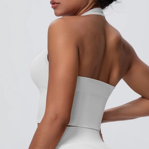 Detail of white high-impact sports bra showing ribbed hem and seamless knit texture
