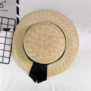 Retro French straw boater hat with black ribbon and bow for summer beach sun protection