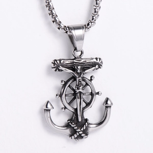 Detailed view of silver viking anchor pendant with cross and helm on white background