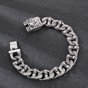 Detailed macro view of punk skull link bracelet in vintage stainless steel finish