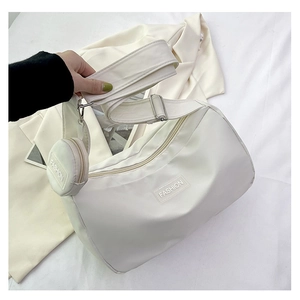 Detailed top view of a white nylon tote bag with wide strap and round coin purse