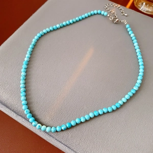 Detail of turquoise beaded necklace showing silver metal clasp and extension chain