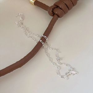 Minimalist 925 sterling silver paperclip chain necklace wrapped on a leather bag strap