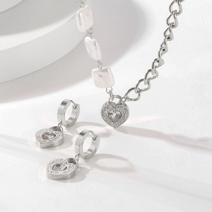 Silver heart necklace and earrings set with shell beads and sparkling crystals