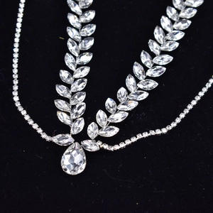 Detailed close-up of bridal forehead chain featuring marquise and teardrop rhinestones
