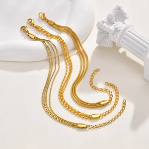 Three-layer gold stainless steel bracelet featuring snake, flat, and olive bead chains