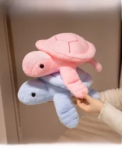 Soft plush turtle dolls in pink and blue featuring detailed shell stitching and black eyes