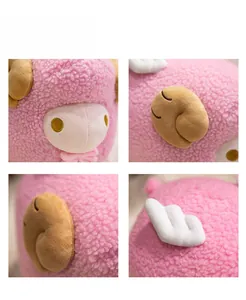 Close-up of pink sheep plush toy showing curly sherpa fleece texture and embroidery
