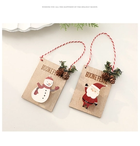 Detail of wooden Christmas ornaments with snowman, Santa, and mini pinecone accents