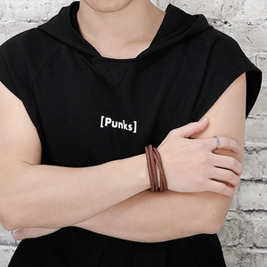 Male model wearing brown multi-layer braided leather wrap bracelet and silver metal ring