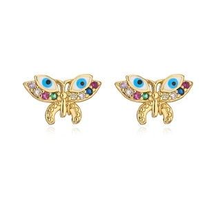Close-up of gold butterfly stud earrings with colorful stones and blue eye pattern