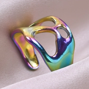 Macro detail of iridescent rainbow plating on asymmetrical open stainless steel ring