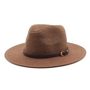 Detailed texture of dark brown woven straw fedora hat with a leather band and gold buckle