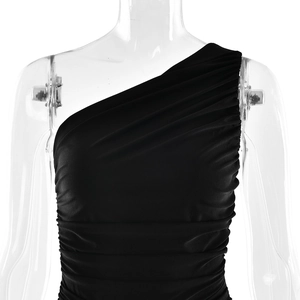 Detail of black one-shoulder ruched dress showing fabric texture and side gathering