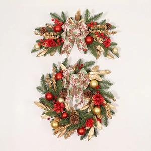 Christmas wreath and wall hanging with red gold baubles and pine cones on white backdrop