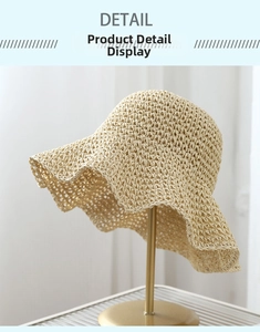 Close-up of beige woven straw hat showing detailed mesh crochet texture and wavy brim