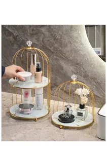 Detail of birdcage iron cosmetic rack with gold finish and marble pattern trays