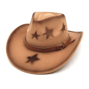 Detail of vintage brown wool cowboy hat featuring star prints and leather band decoration