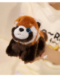 Close-up of a plush red panda toy with soft fur texture and sparkling purple eyes