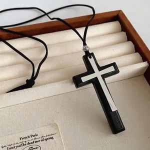 Double cross pendant necklace with black wood and silver metal on adjustable leather cord