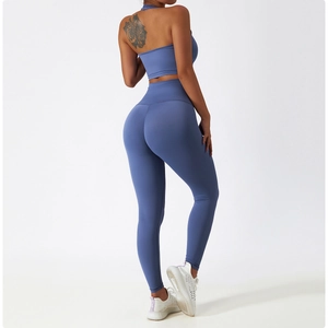 Back view of high-waist peach butt yoga leggings and backless sports bra in misty blue